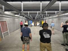 codex clipboard db57da7d 9bd0 4f1e 9157 fbe769043b13 Participants at an indoor USPSA match